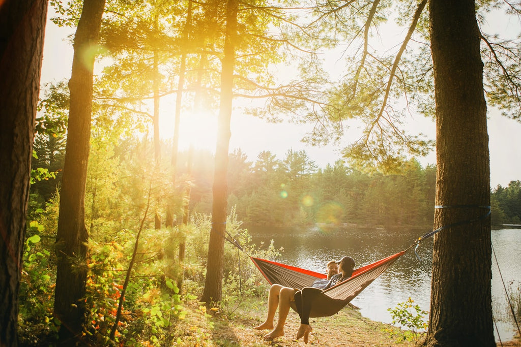 Relaxing in a camping hammock between trees