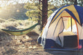 Ultralight camping hammock hanging between trees in forest
