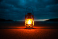 Glowing camping lantern at a campsite at night